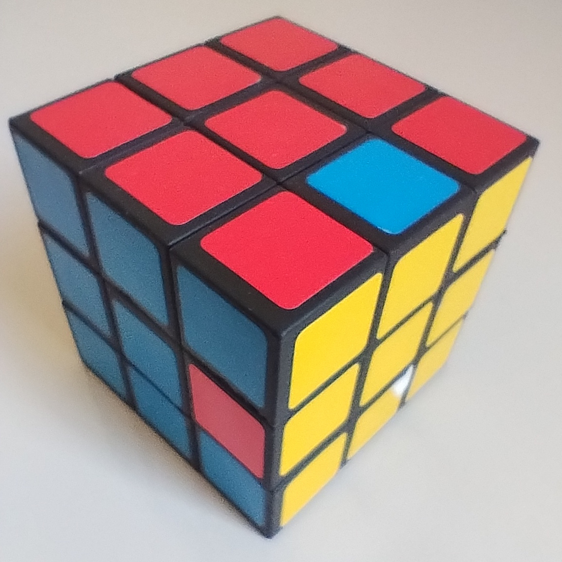 An almost solved Rubik's cube, with only 2 blocks left to solve.